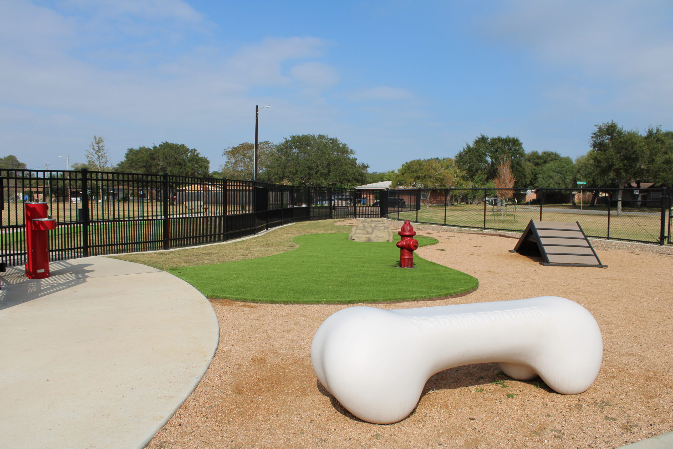 a dog park with bone-shaped bench and fire hydrant (junction city dog park concept)